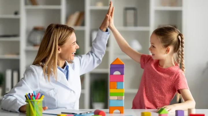 Colorful image of a pediatric therapist engaging a child in a playful therapy session, using innovative techniques and interactive materials to make therapy fun and enjoyable.