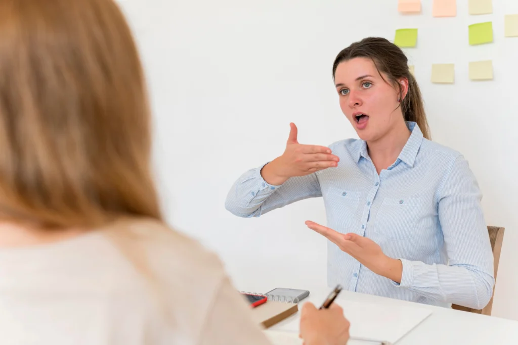 Speech therapist demonstrating vocal exercises to a patient for improving voice quality and treating vocal cord disorders.